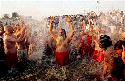 Indian spiritual leader His Holiness Mahamandaleshwar Paramhans Swami Maheshwaranandji takes a holy dip along with his western devotees at the confluence of the rivers Ganges, Yamuna and mythical Saraswati on the Makar Sankranti festival, an auspicious day during the 45-day long Ardh Kumbh Mela festival, in Allahabad, India, Sunday, Jan. 14. ((c) Associated Press)